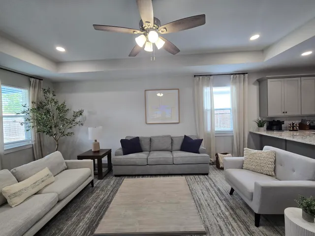 a living room with furniture and a large window