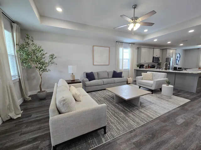 a living room with furniture and a chandelier
