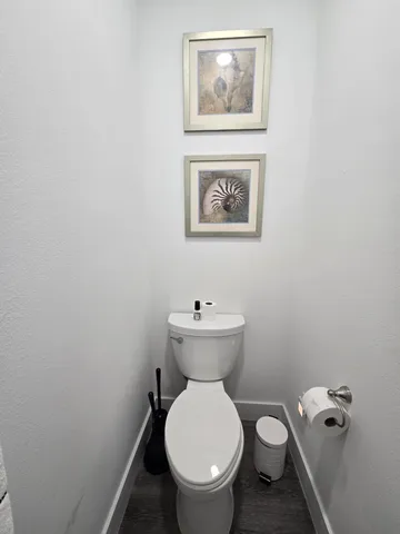 a white toilet sitting next to a white sink