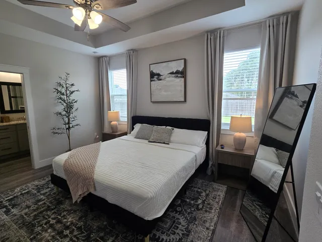 a bedroom with a bed and a chandelier