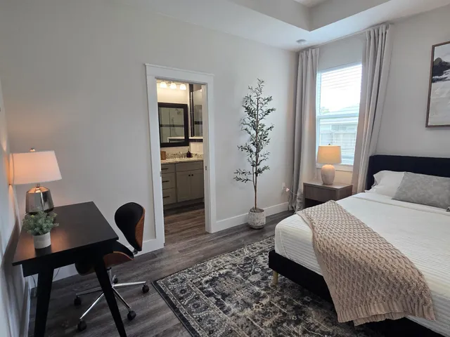 a bedroom with a bed and a desk