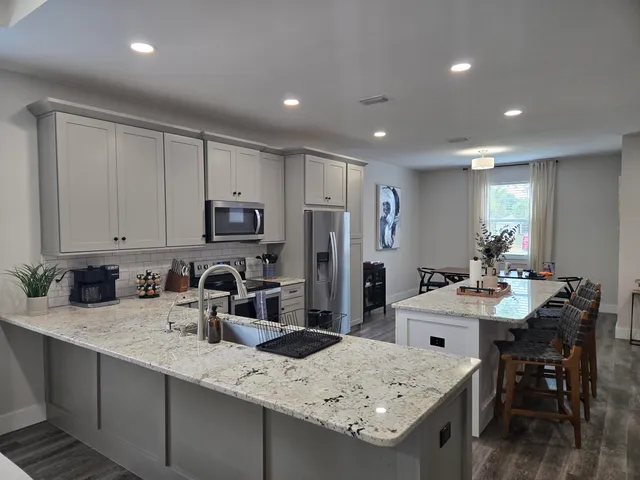 a kitchen with a sink refrigerator and cabinets