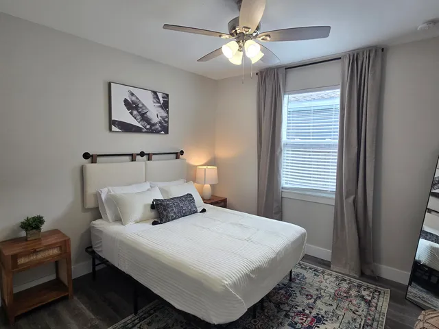 a bedroom with a large bed and a window