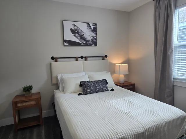 a bedroom with a bed and a window