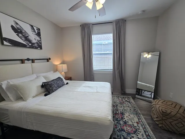 a bedroom with a bed and a chandelier