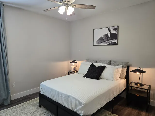 a bedroom with a bed and a chandelier