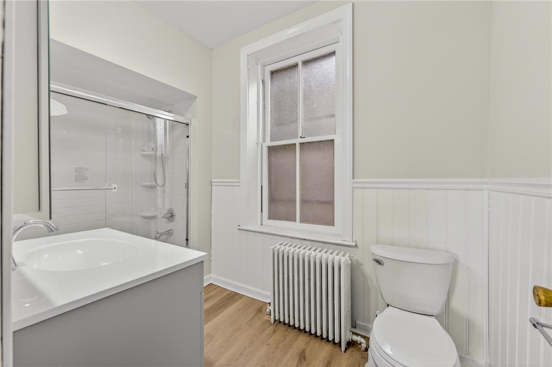 65 2nd Street Slatington, PA 18080 - Photo 33 of 46 This bathroom features wainscoting and a shower with a sliding glass door, providing a clean, functional space.