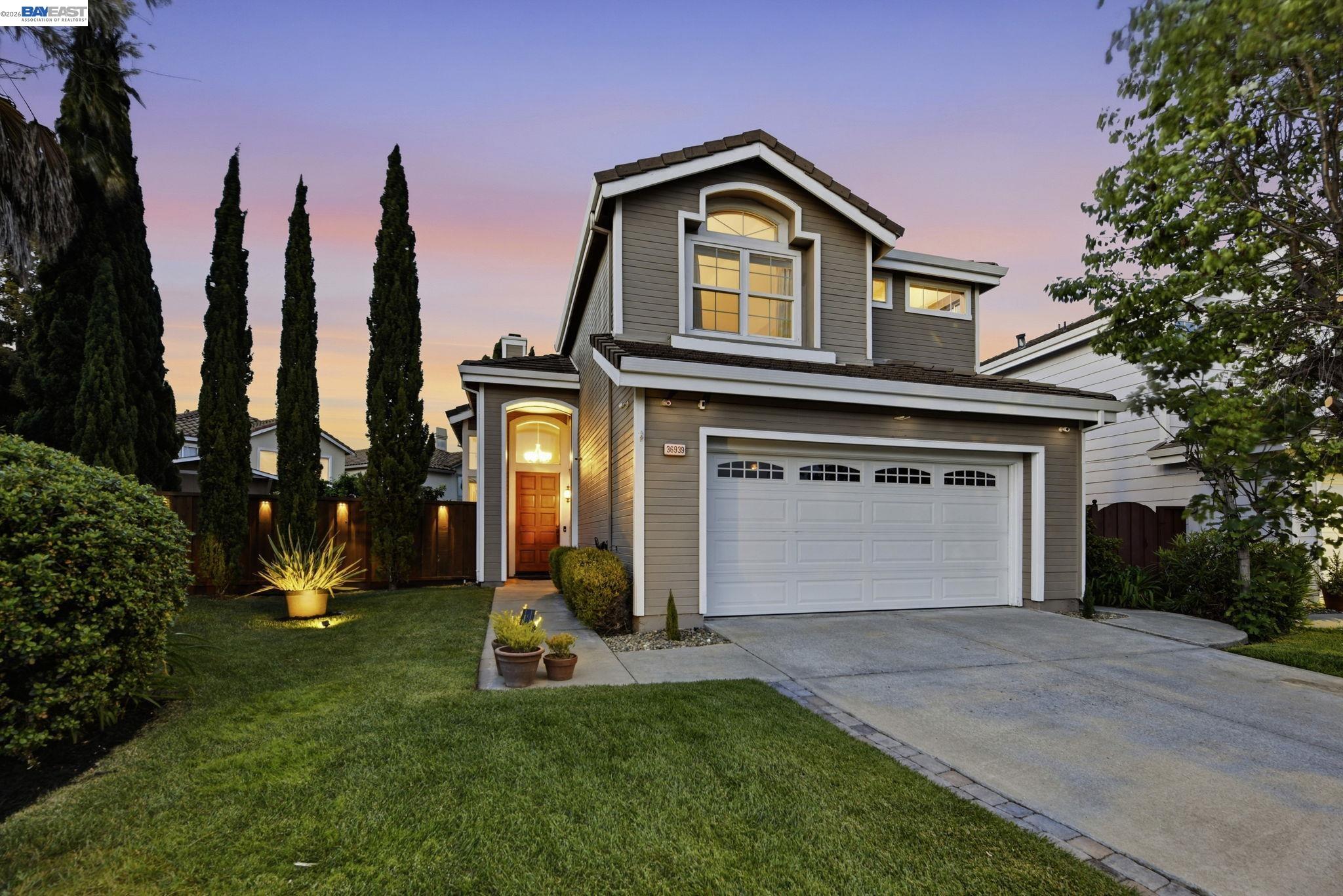 36939 Papaya Street Newark, CA 94560 - Photo 1 of 49 a front view of a house with a yard and garage