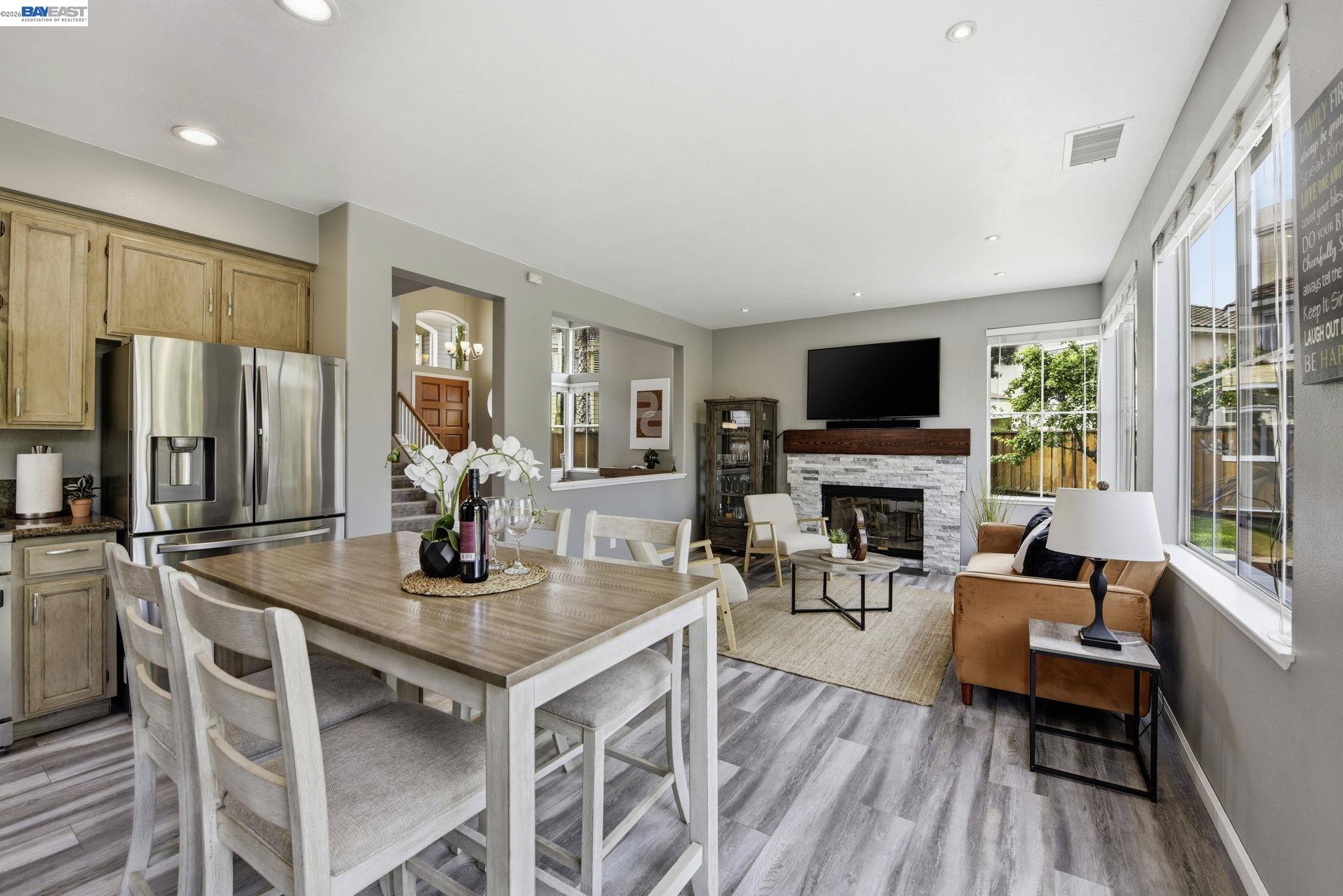 36939 Papaya Street Newark, CA 94560 - Photo 11 of 49 a dining room with furniture a fireplace and wooden floor