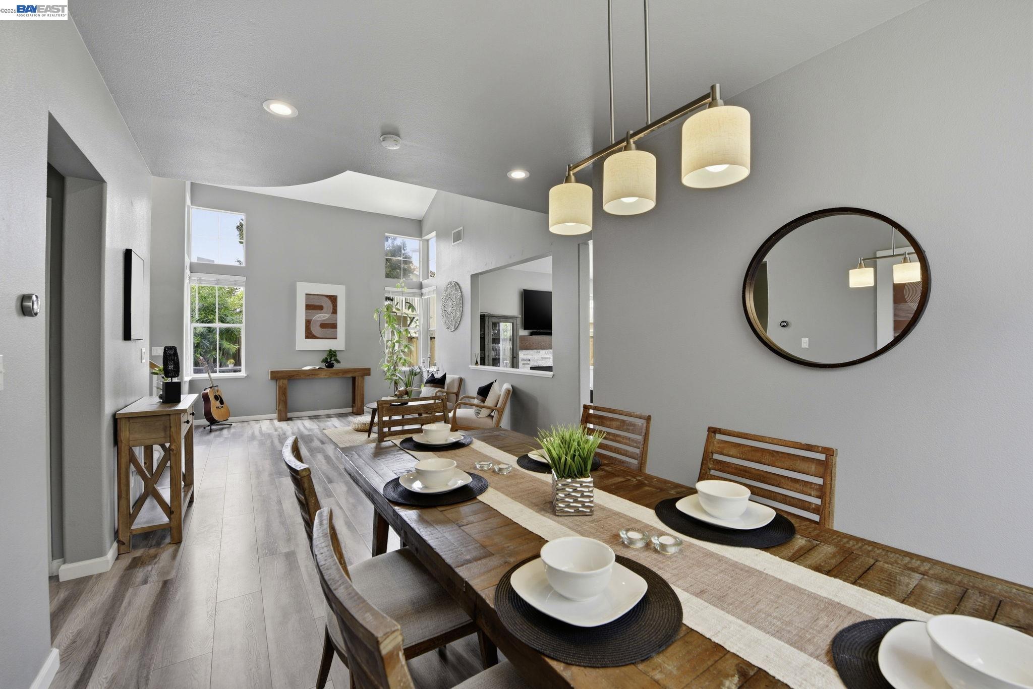 36939 Papaya Street Newark, CA 94560 - Photo 16 of 49 a dining room with furniture a mirror and wooden floor
