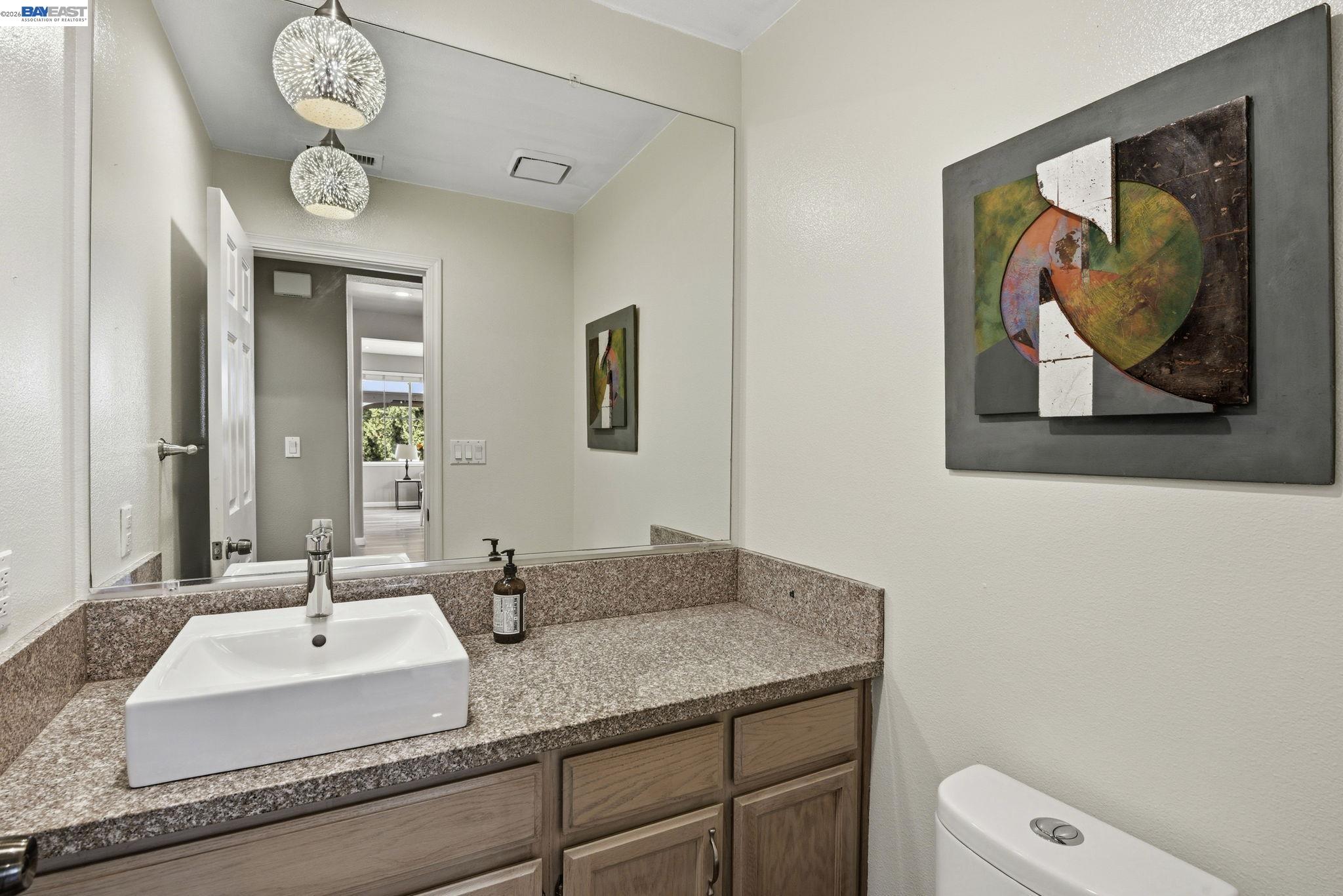 36939 Papaya Street Newark, CA 94560 - Photo 17 of 49 a bathroom with a granite countertop sink and a mirror