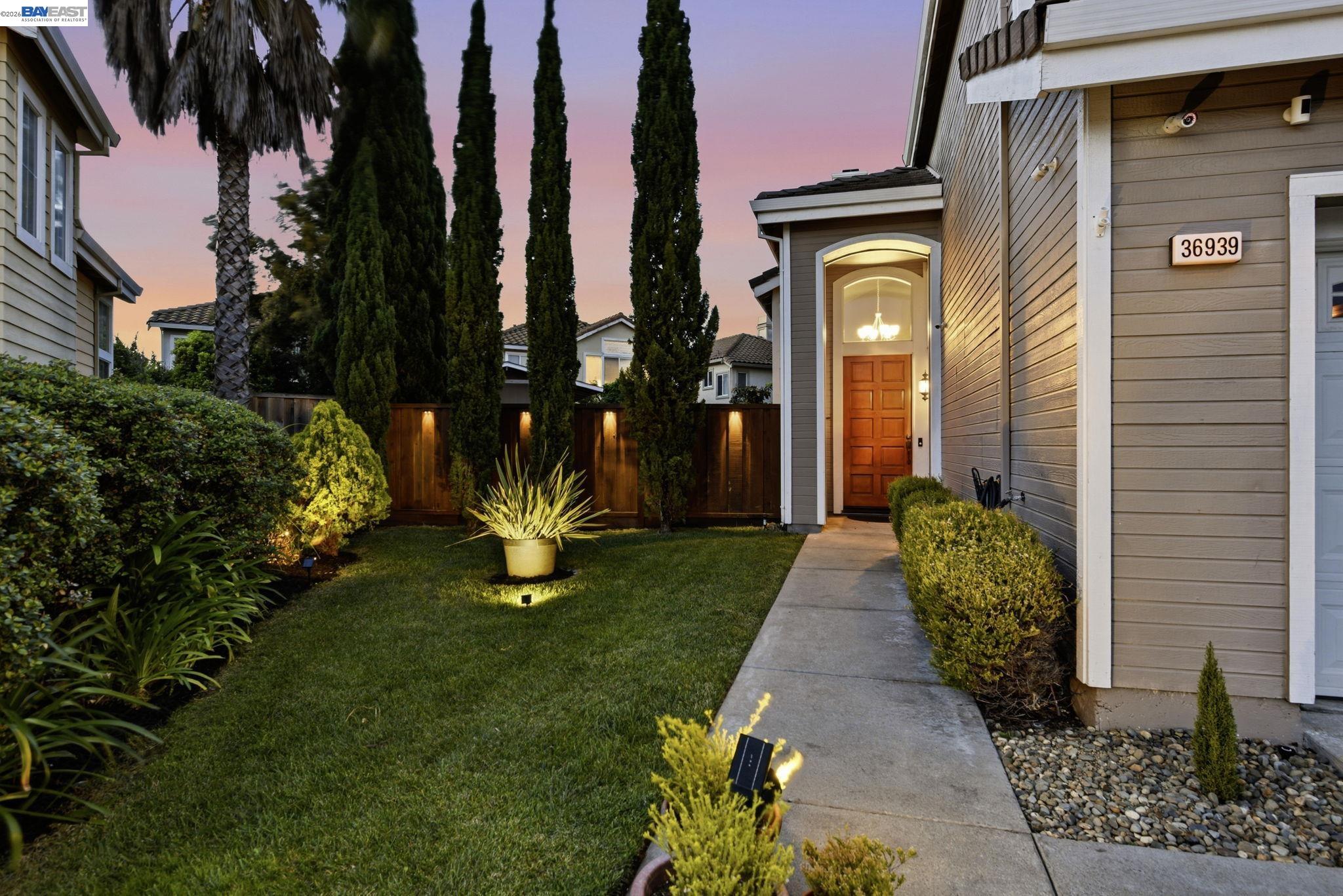 36939 Papaya Street Newark, CA 94560 - Photo 2 of 49 a view of a brick house with a yard and plants