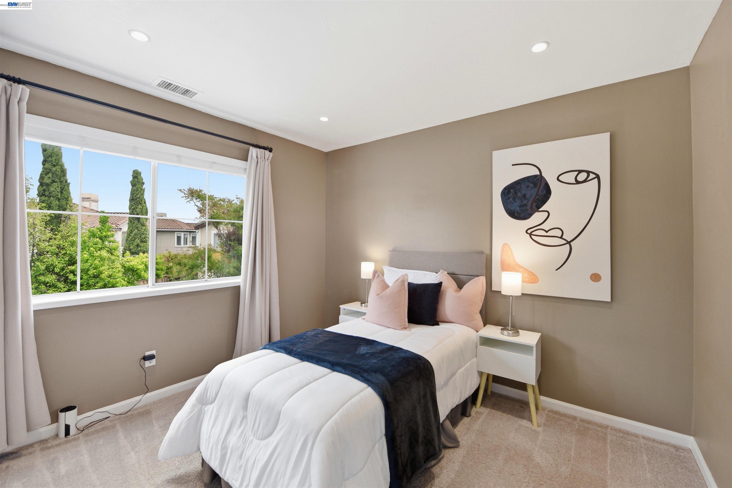 36939 Papaya Street Newark, CA 94560 - Photo 27 of 49 a bedroom with a bed and a painting on the wall