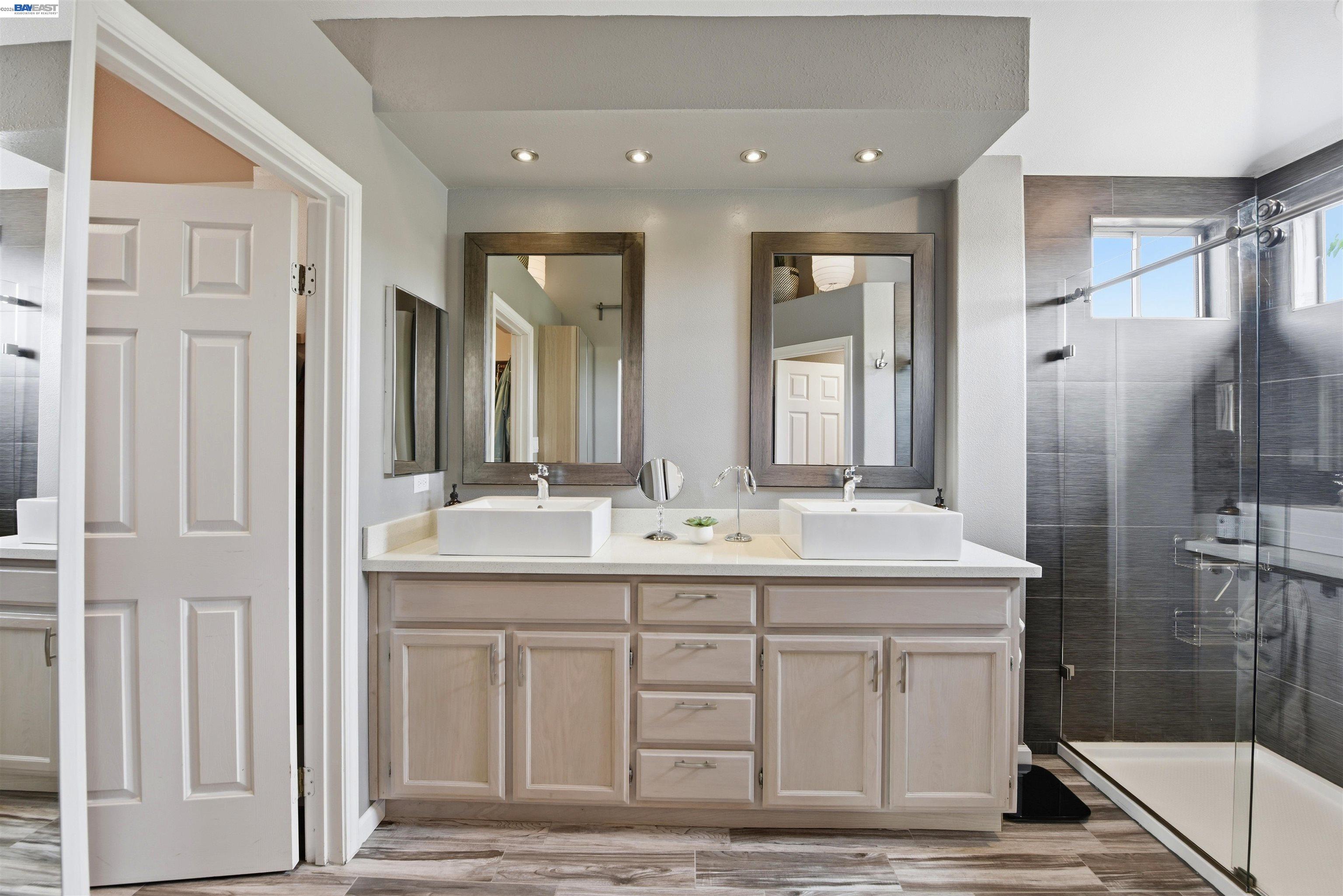 36939 Papaya Street Newark, CA 94560 - Photo 30 of 49 a bathroom with a double vanity sink mirror and shower