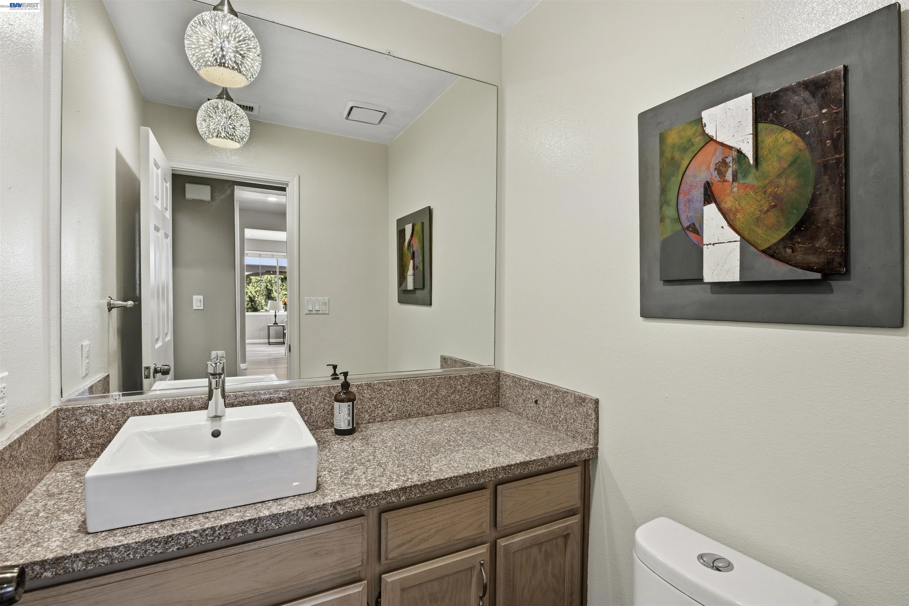36939 Papaya Street Newark, CA 94560 - Photo 32 of 49 a bathroom with a granite countertop sink and a mirror