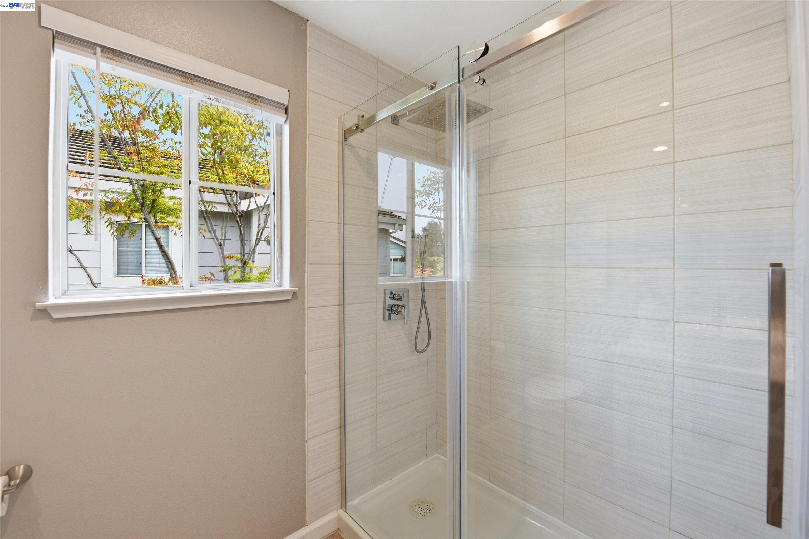36939 Papaya Street Newark, CA 94560 - Photo 34 of 49 a bathroom with a glass shower door
