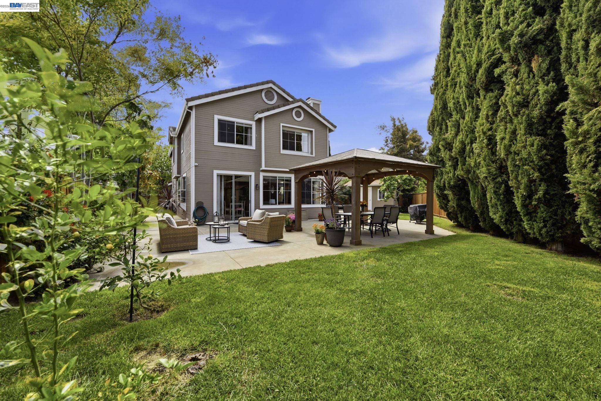 36939 Papaya Street Newark, CA 94560 - Photo 42 of 49 a view of a yard with a table and chairs under an umbrella