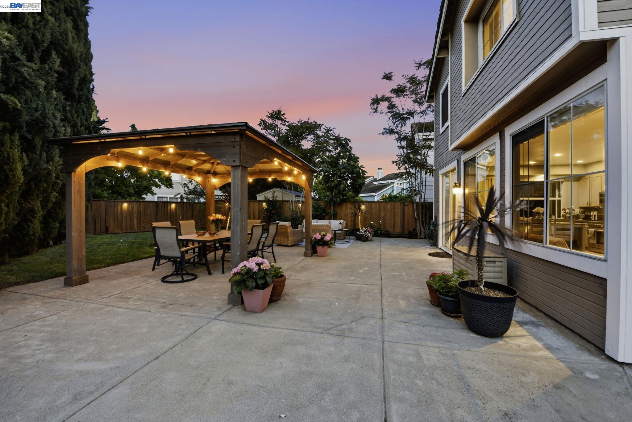 36939 Papaya Street Newark, CA 94560 - Photo 47 of 49 a view of a patio with table and chairs potted plants with wooden fence