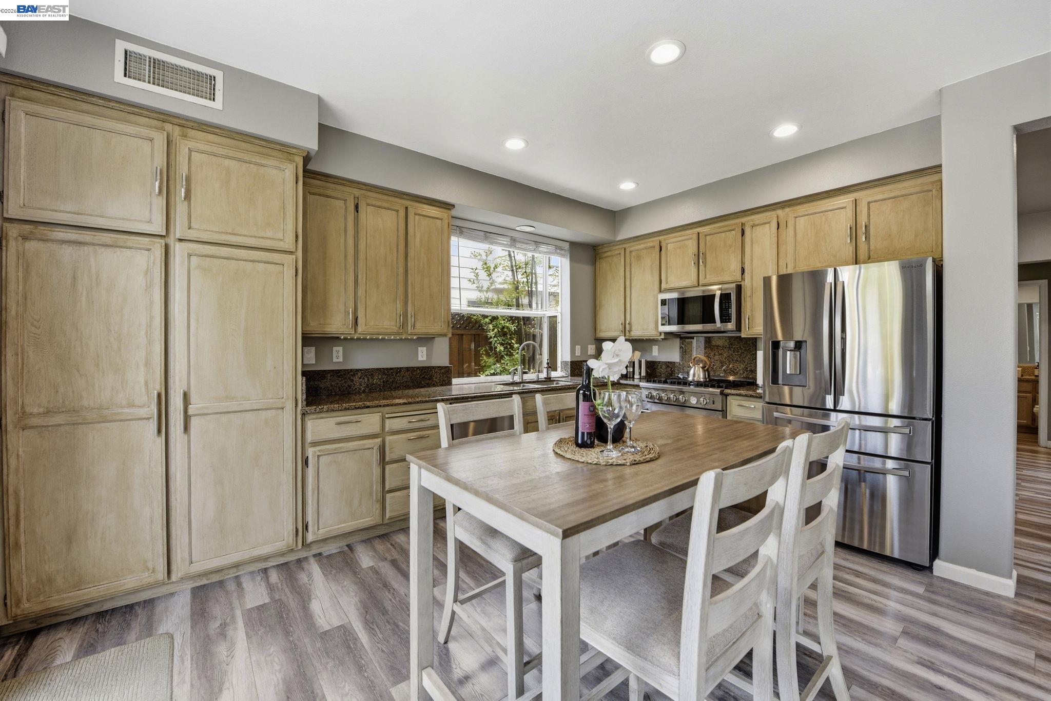 36939 Papaya Street Newark, CA 94560 - Photo 10 of 49 a kitchen with refrigerator cabinets and wooden floor