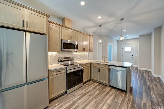a large white kitchen with a large window