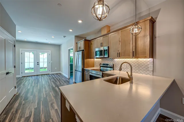 a kitchen with a sink stove and microwave