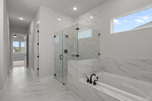 a bathroom with a bathtub and a shower