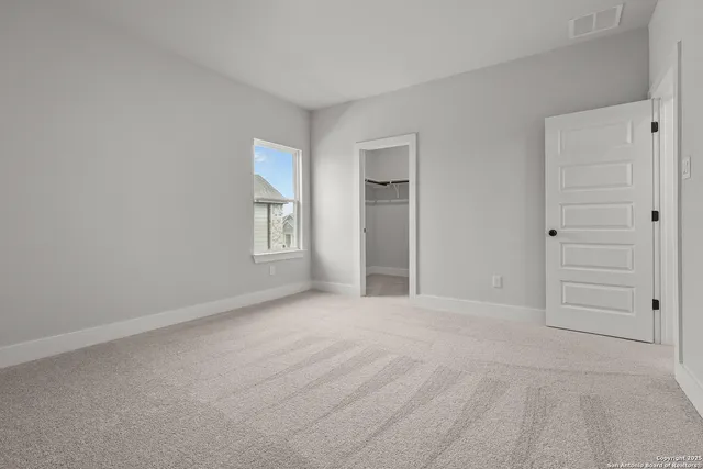 an empty room with closet and window
