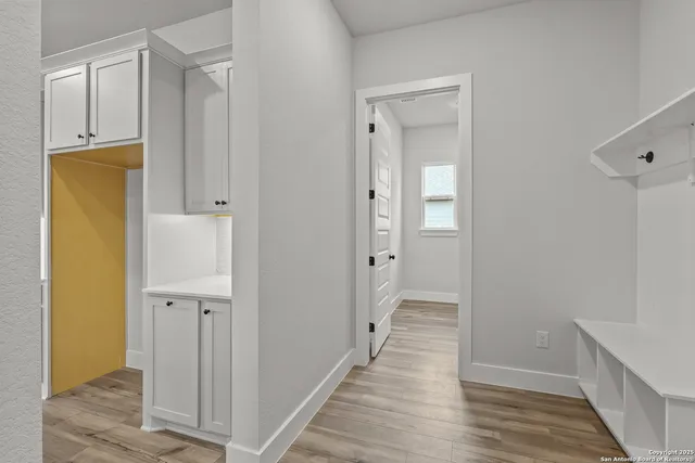 a view of a hallway with wooden floor