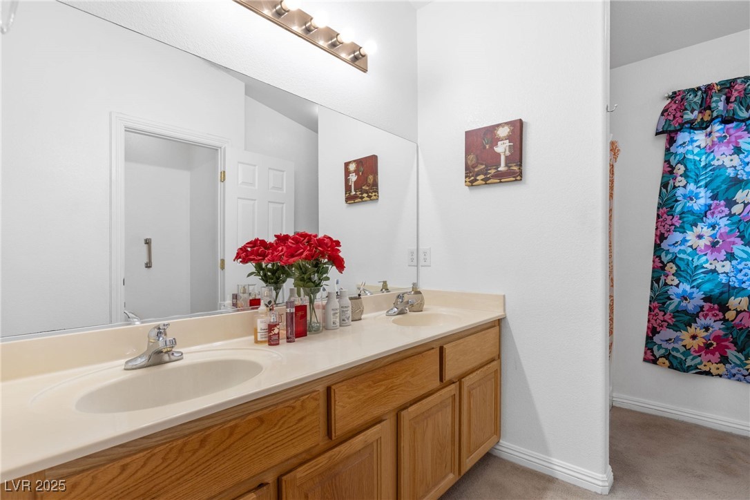 1289 Large Cap Drive, Unit 2 Henderson, NV 89074 - Photo 25 of 32 Full bath featuring double vanity and light colored carpet
