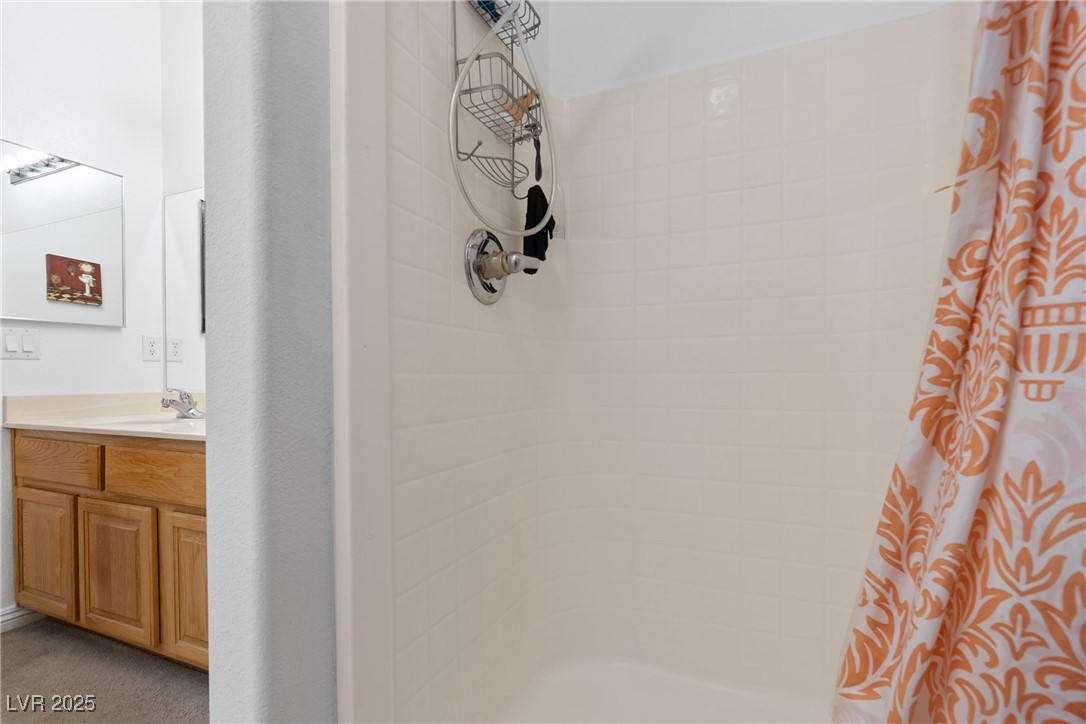1289 Large Cap Drive, Unit 2 Henderson, NV 89074 - Photo 26 of 32 Full bathroom with vanity and tiled shower