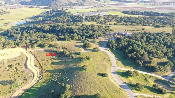 a view of a lake with beach and green space