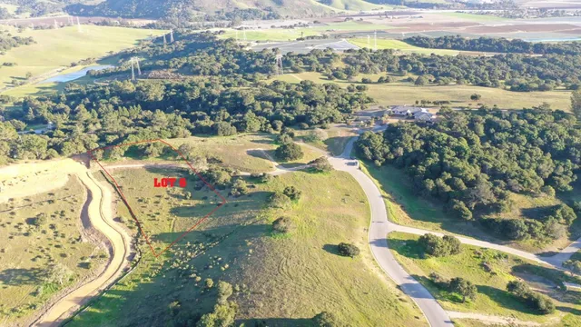 a view of a lake with beach and green space