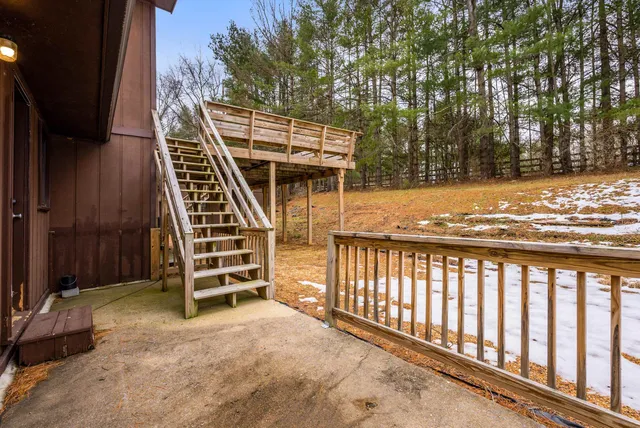 a view of a kitchen with chair and white walls