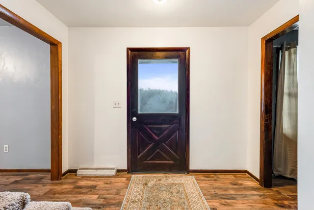 a view of a living room with furniture and wooden floor