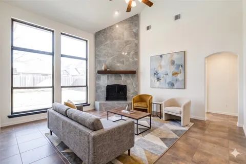 a living room with furniture and a fireplace