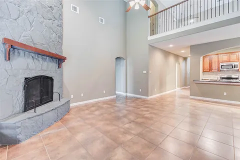 a view of an empty room and a fireplace