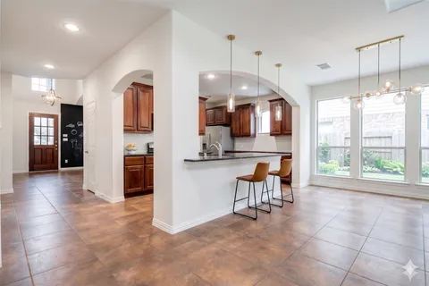 a view of kitchen with refrigerator and window