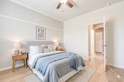 a bedroom with a bed and a chandelier