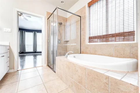 a bathroom with a bathtub and a shower