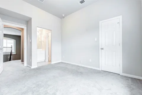 an empty room with closet and a bathroom