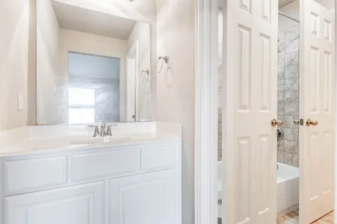 a bathroom with a double vanity sink and mirror