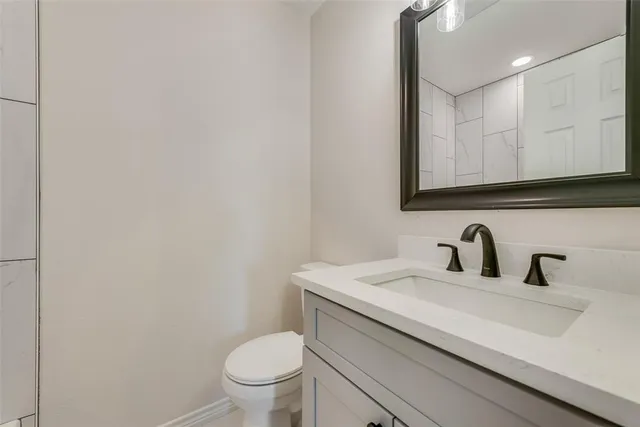 a bathroom with a sink a toilet and mirror