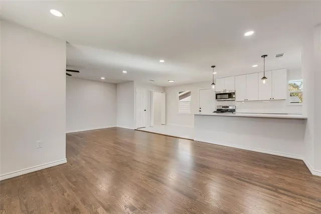 a view of kitchen with kitchen island microwave and stove
