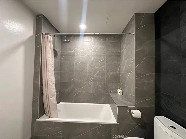 a bathroom with a bathtub and shower
