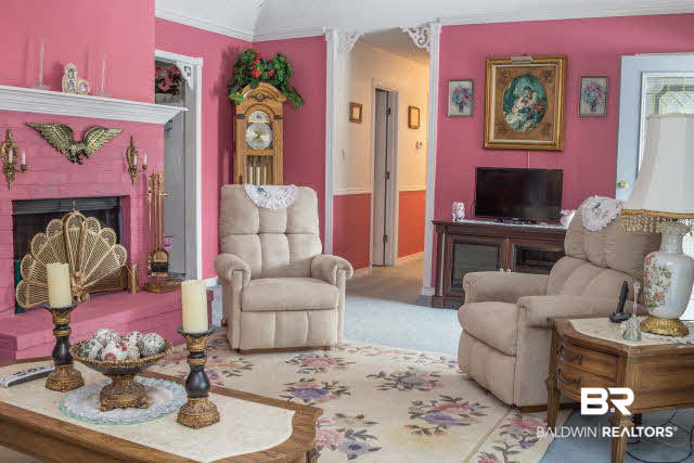 1504 North Cedar Street Foley, AL 36535 - Photo 2 of 16 Formal living room with wood burning fireplace. Easy to paint in your own color palette.