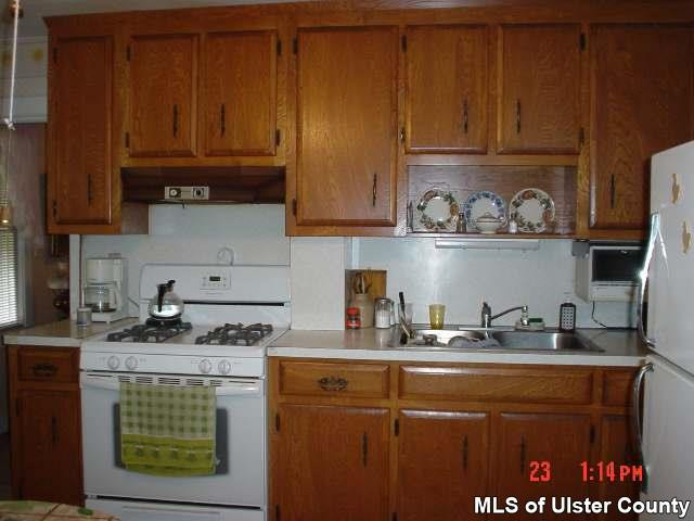 4130 Atwood Road Stone Ridge, NY 12484 - Photo 3 of 5 a kitchen with stainless steel appliances granite countertop a sink stove and cabinets