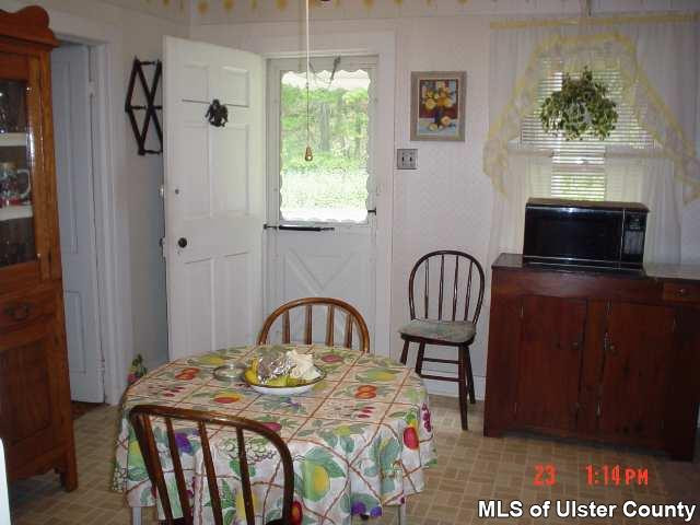 4130 Atwood Road Stone Ridge, NY 12484 - Photo 5 of 5 a bedroom with a bed and a fireplace with the outer view