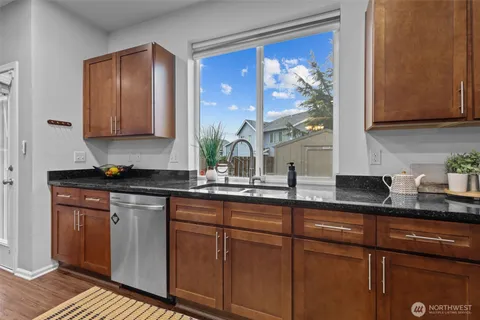 a kitchen with stainless steel appliances granite countertop a sink stove and cabinets