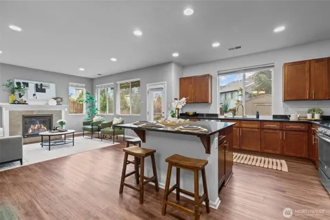 a kitchen with sink cabinets and wooden floor