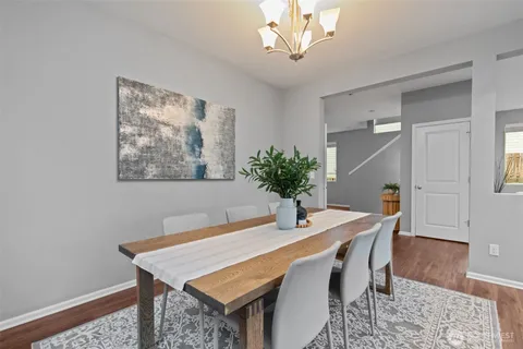 a dining room with a table and chairs
